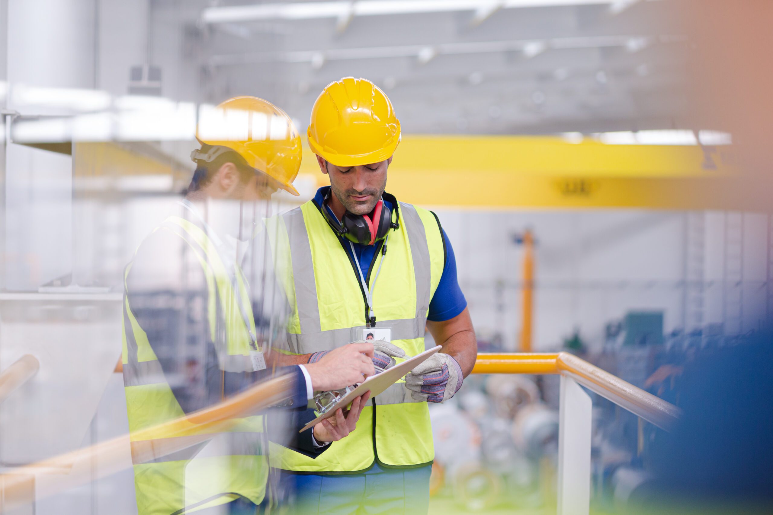 Supervisor and worker talking in steel factory