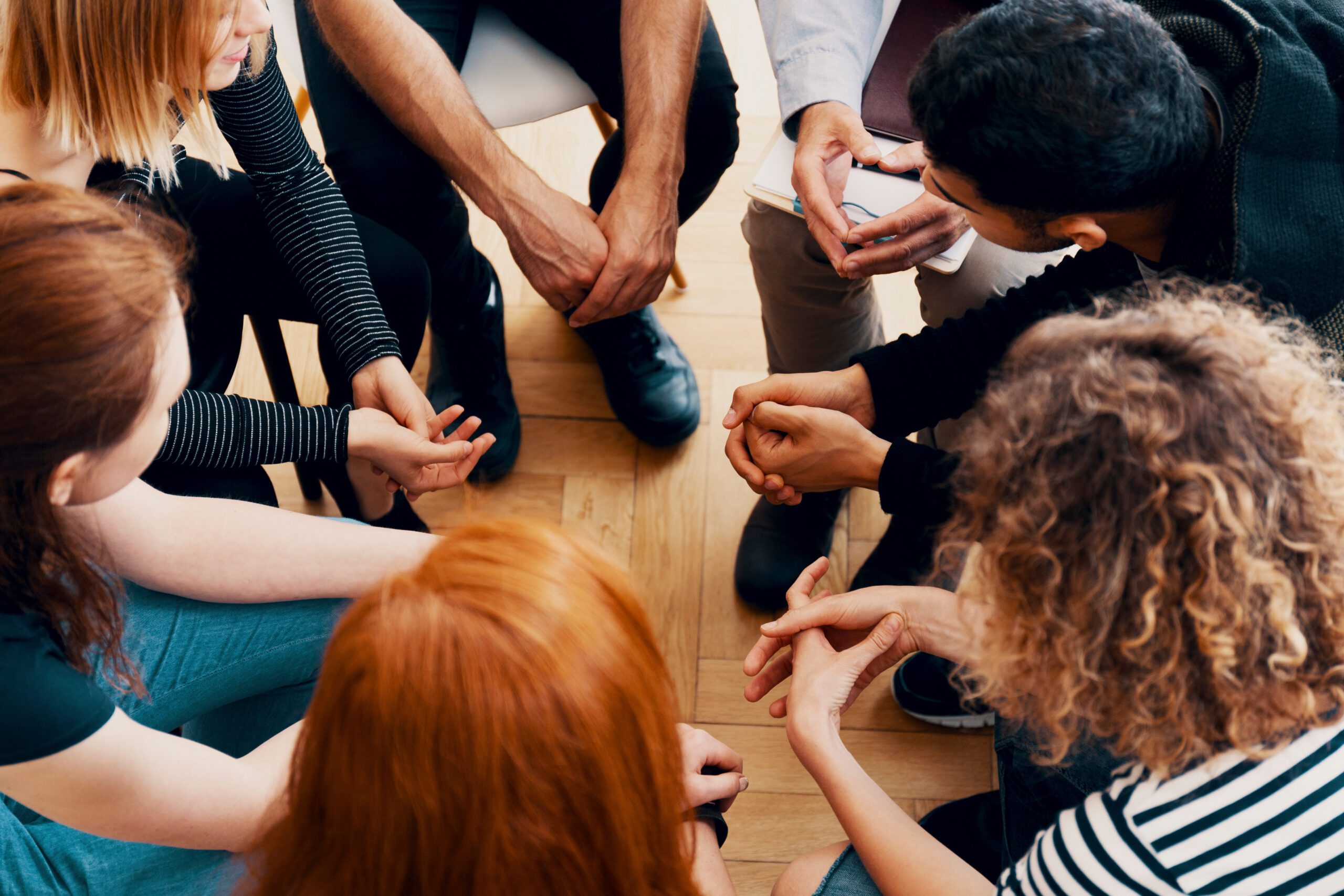 High angle of a group of teenagers sitting in a circle during gr