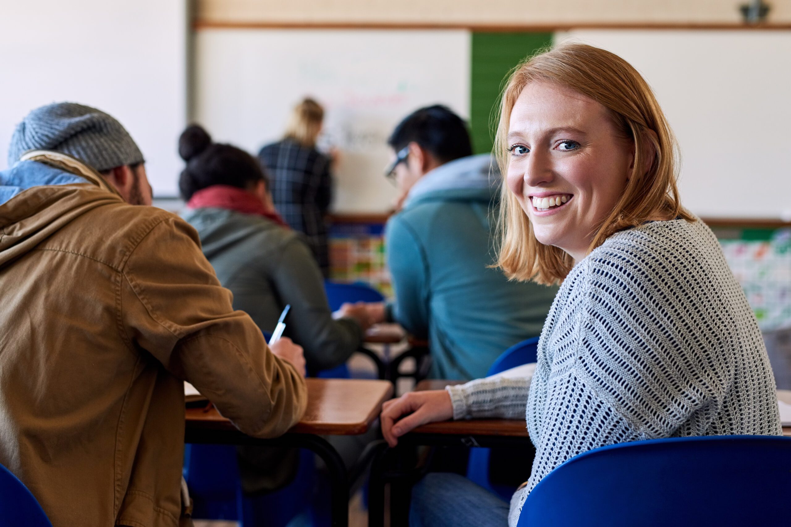 Happy, portrait and woman as university student for classroom, lecture and studying with back. Female person, smile and scholarship for education, knowledge and learning in college or campus